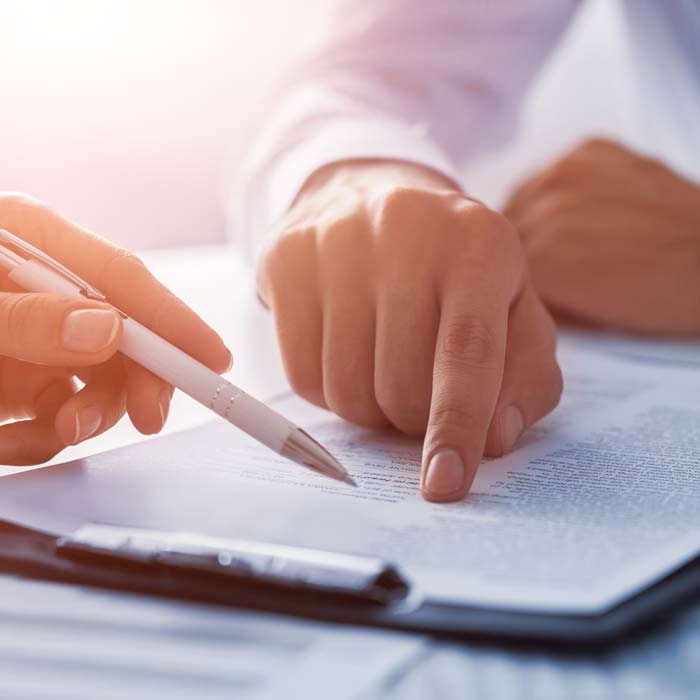 Two business professionals reviewing a document