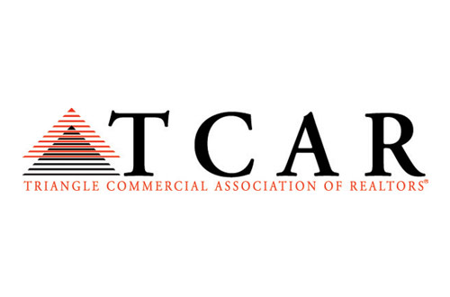 TCAR Logo - Black uppercase TCAR with orange uppercase below and triangle graphics to left